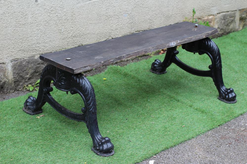 A CAST IRON DOUBLE SIDED GARDEN BENCH, the two scroll cast cabriole supports on paw feet, with later Image