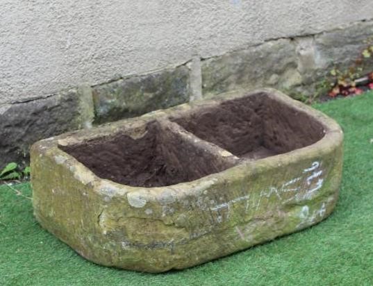 A SANDSTONE TROUGH of well cut D form with central division, 30" x 17 1/4" x 9 1/2" Image