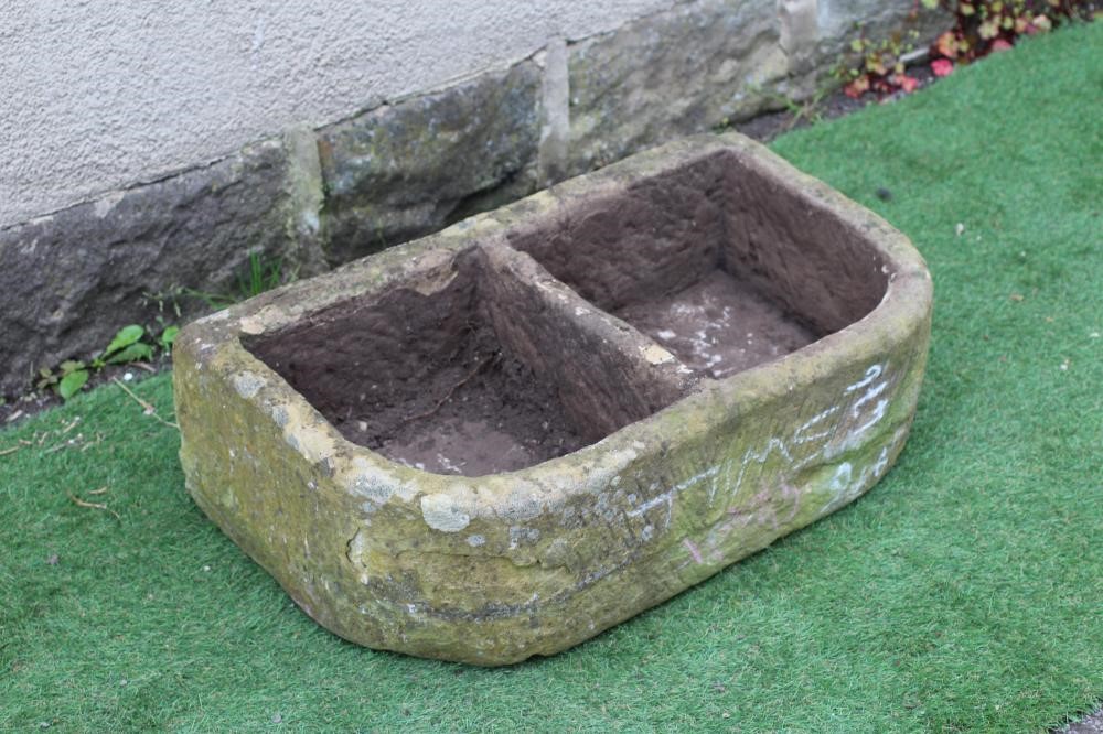 A SANDSTONE TROUGH of well cut D form with central division, 30" x 17 1/4" x 9 1/2" Image