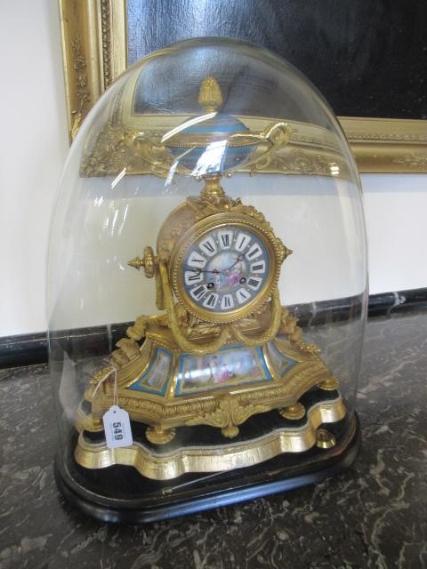 A FRENCH GILT METAL AND PORCELAIN MANTEL CLOCK Image