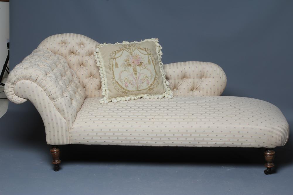 A VICTORIAN STAINED BEECH FRAMED CHAISE LONGUE button upholstered in a cream striped floral weave Image