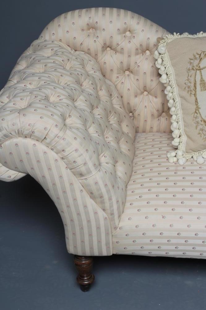 A VICTORIAN STAINED BEECH FRAMED CHAISE LONGUE button upholstered in a cream striped floral weave Image