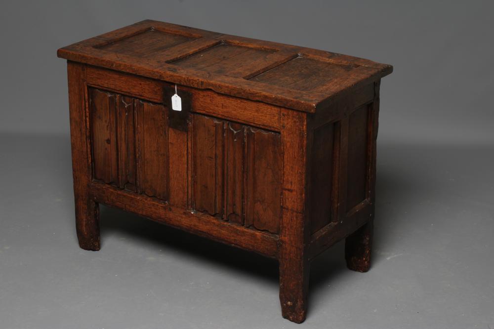 A SMALL OAK PANELLED COFFER, the hinged lid opening to interior with till box, the fascia with a Image