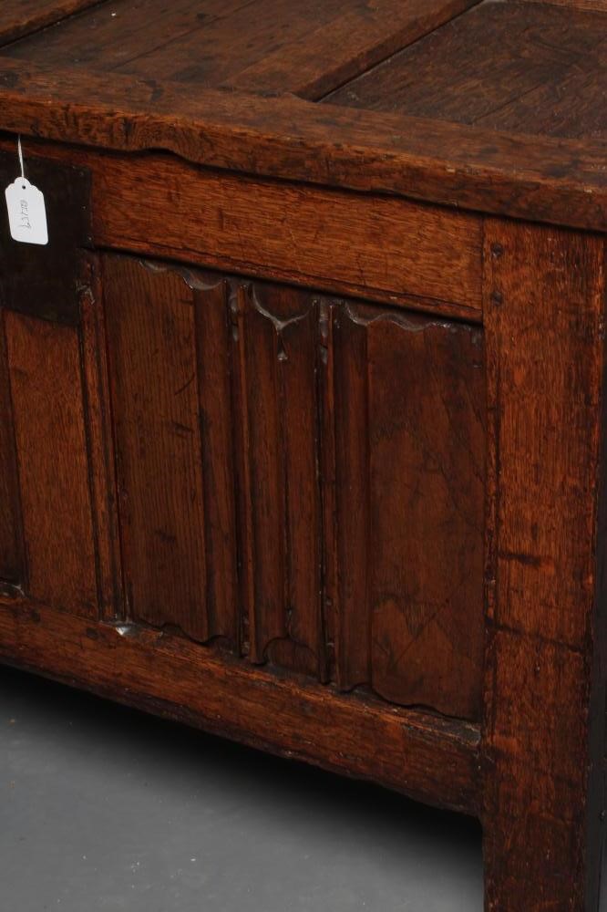 A SMALL OAK PANELLED COFFER, the hinged lid opening to interior with till box, the fascia with a Image