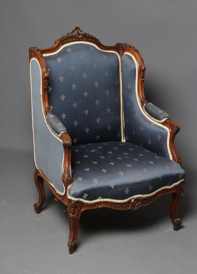 A FRENCH WALNUT SHOW FRAME WING ARMCHAIR Image