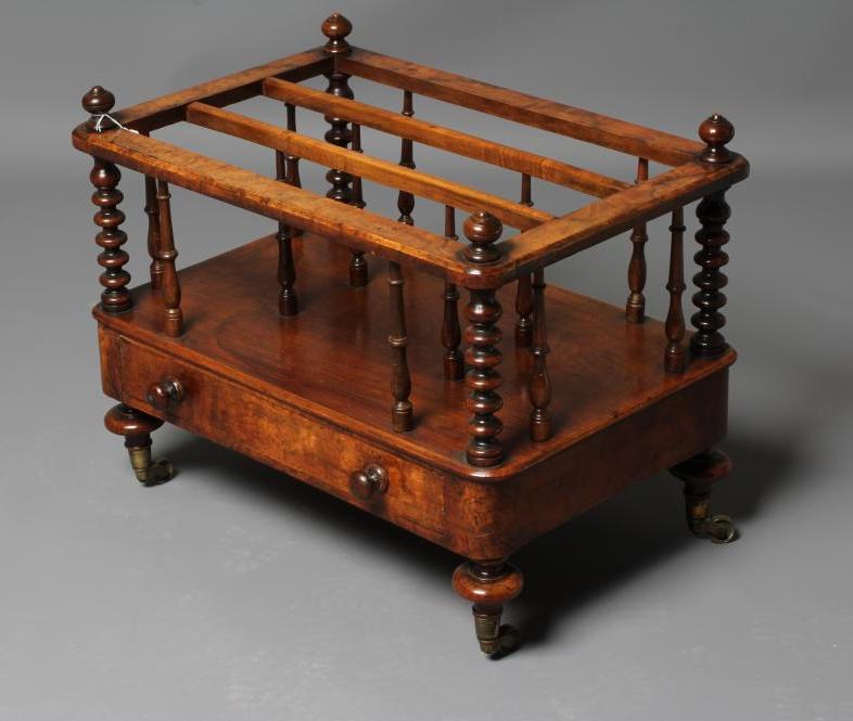 A VICTORIAN BURR WALNUT CANTERBURY of rounded oblong form with baluster turned finials on bobbin Image