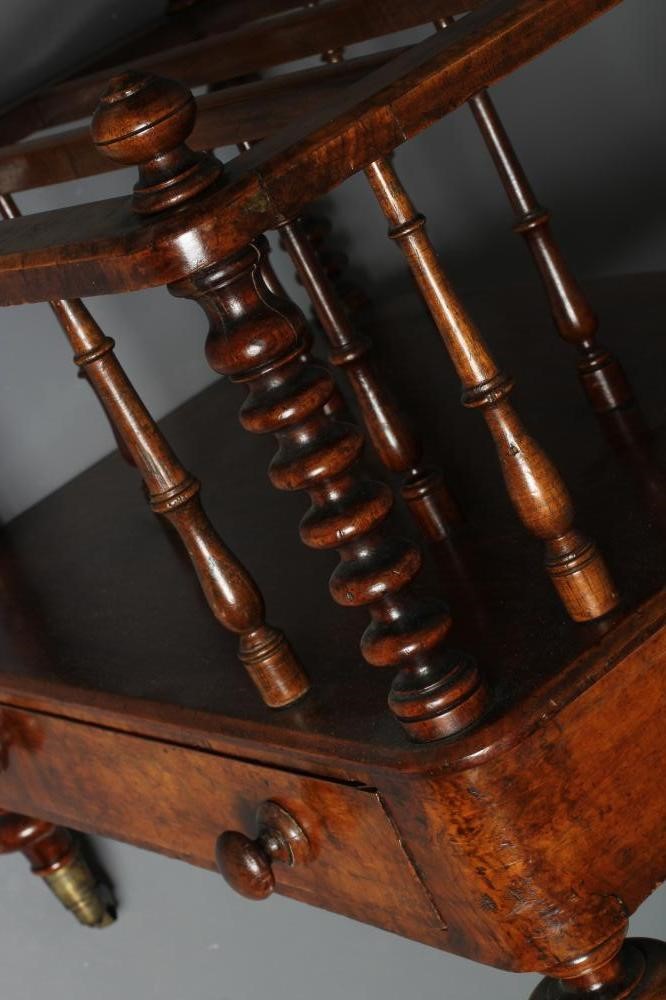 A VICTORIAN BURR WALNUT CANTERBURY of rounded oblong form with baluster turned finials on bobbin Image
