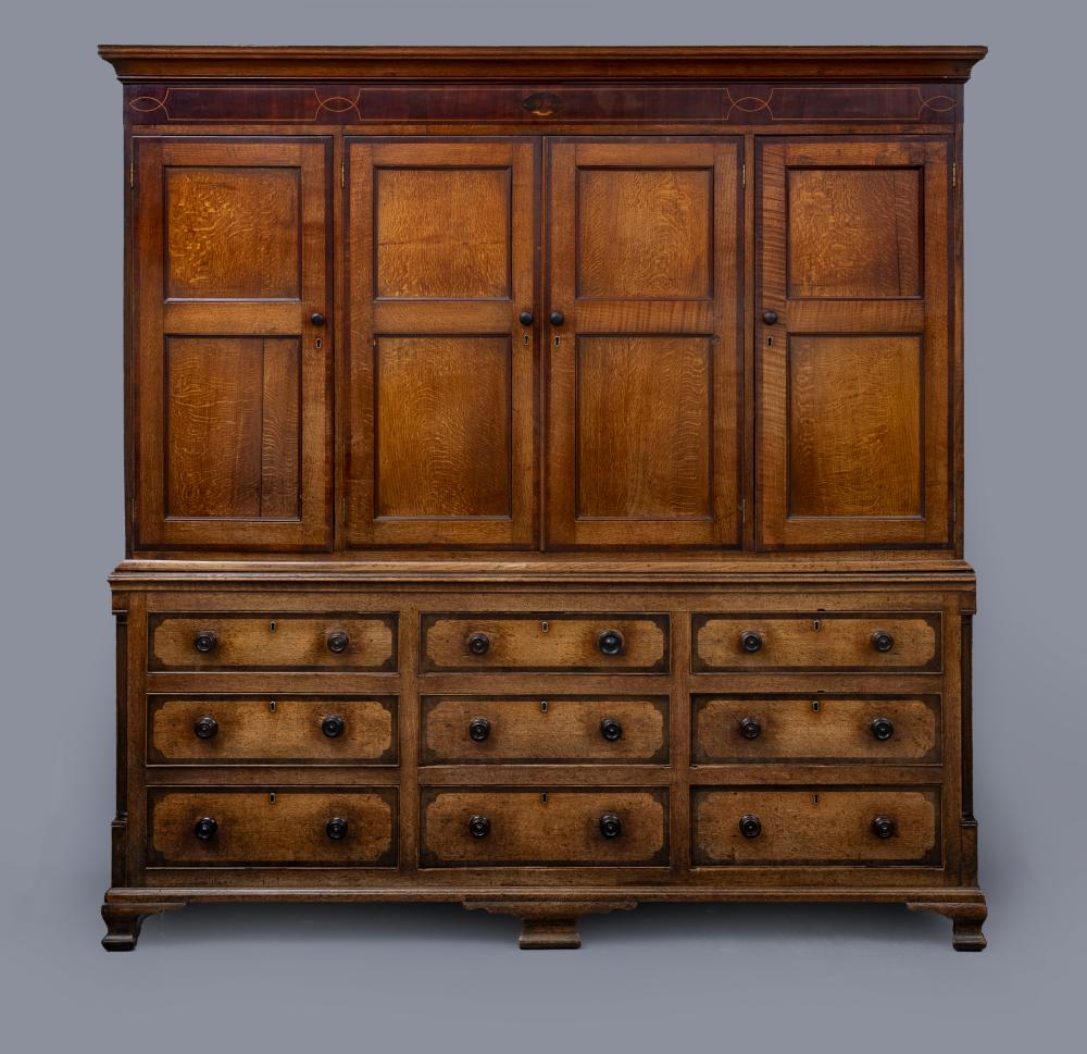 A LARGE GEORGIAN OAK AND MAHOGANY BANDED HOUSEKEEPERS CUPBOARD Image