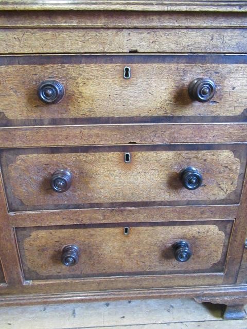 A LARGE GEORGIAN OAK AND MAHOGANY BANDED HOUSEKEEPERS CUPBOARD Image