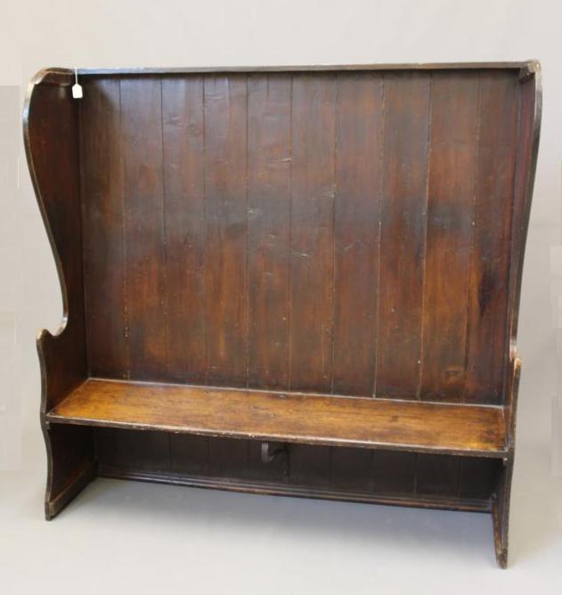 A STAINED PINE WING BACK TAVERN SETTLE, 19th century, with high boarded back, plank seat with Image