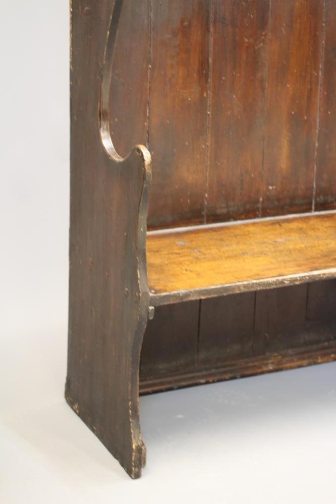 A STAINED PINE WING BACK TAVERN SETTLE, 19th century, with high boarded back, plank seat with Image