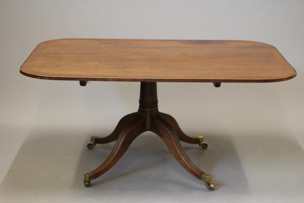A REGENCY 'PLUM PUDDING' MAHOGANY BREAKFAST TABLE Image