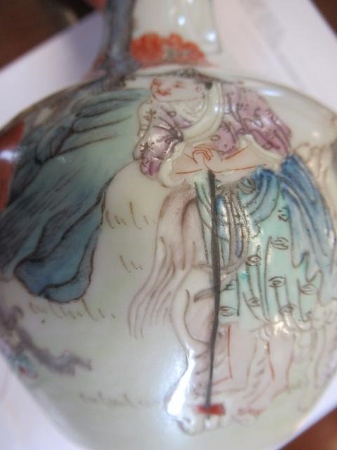 A CHINESE PORCELAIN BOTTLE VASE painted in colours with a vignette of three figures below a gnarled Image