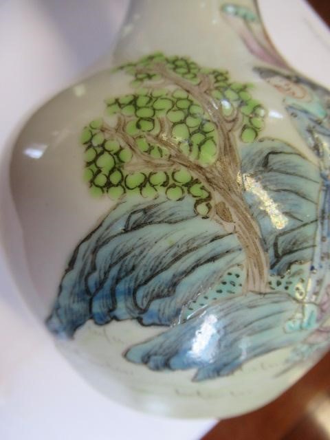 A CHINESE PORCELAIN BOTTLE VASE painted in colours with a vignette of three figures below a gnarled Image