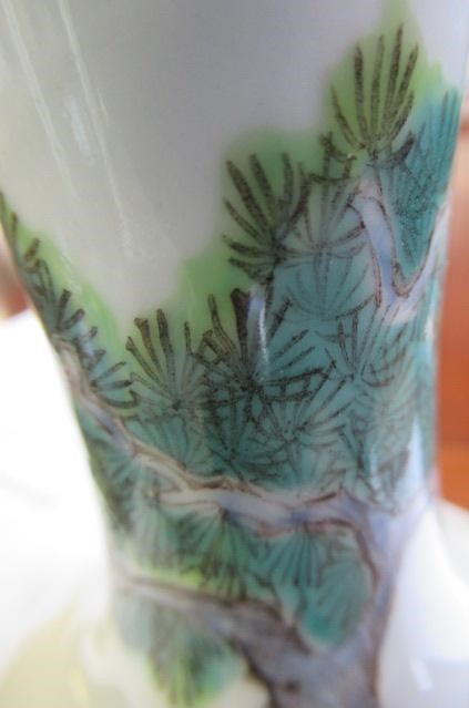 A CHINESE PORCELAIN BOTTLE VASE painted in colours with a vignette of three figures below a gnarled Image