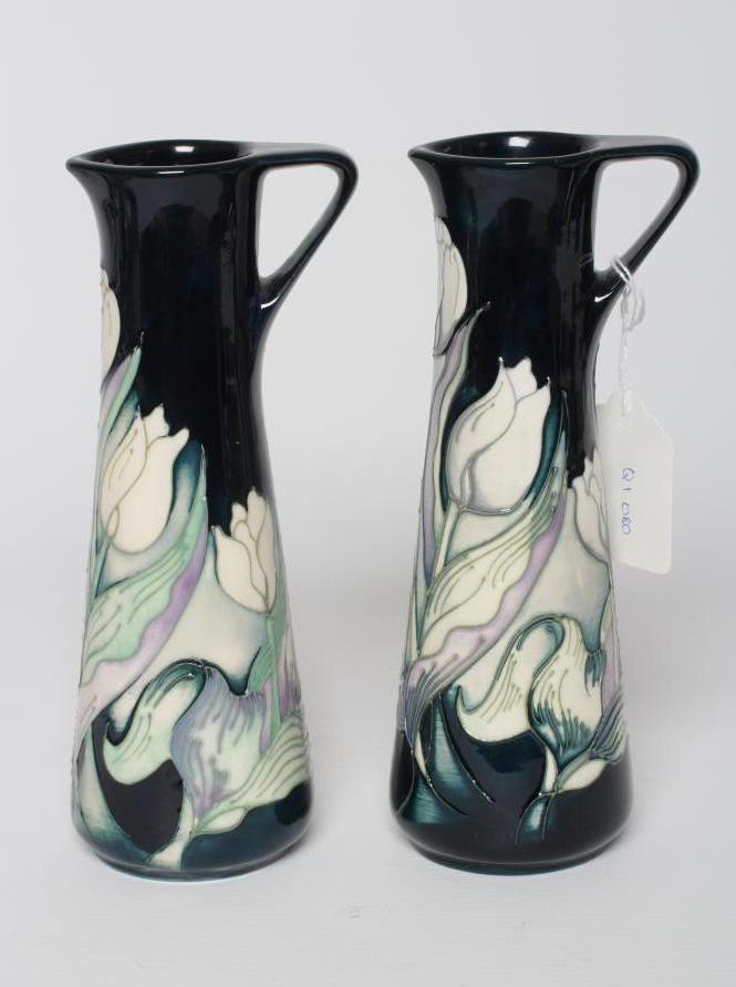 A PAIR OF MOORCROFT POTTERY SNOW TULIP PATTERN SMALL EWERS, 2012, designed by Nicola Slaney, Image