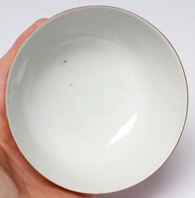 A CHINESE PORCELAIN SMALL BOWL, the iron red exterior reverse decorated with bamboo, six character Image