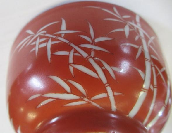A CHINESE PORCELAIN SMALL BOWL, the iron red exterior reverse decorated with bamboo, six character Image