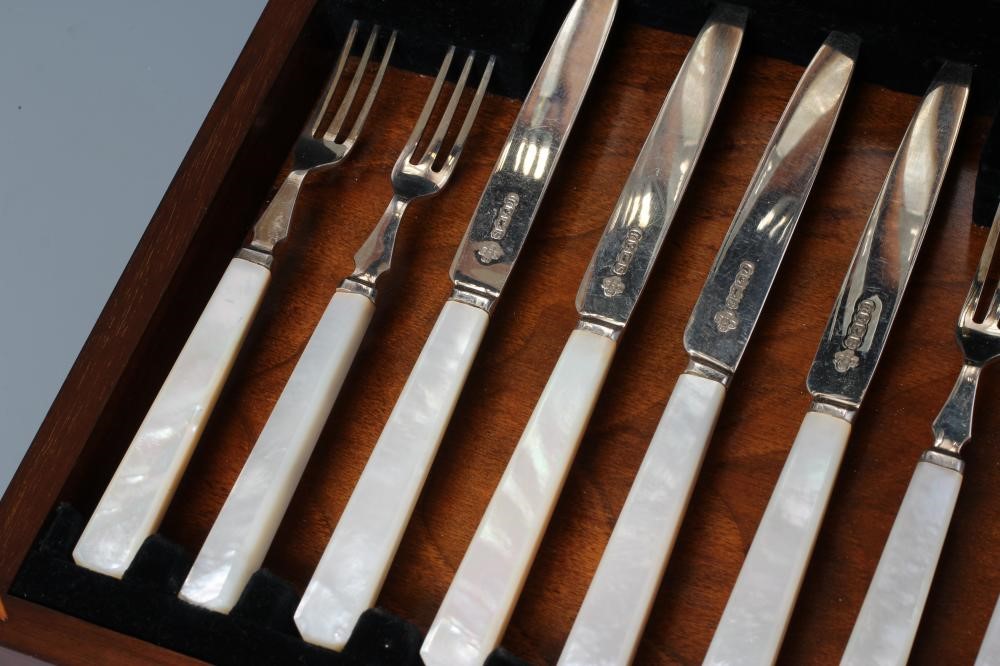 A SET OF EIGHT PAIRS OF SILVER FRUIT KNIVES AND FORKS Image