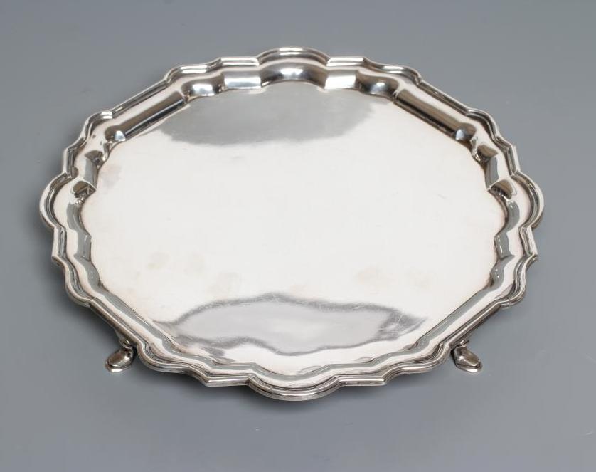 A SILVER SALVER, by Hamilton & Co., London 1927, of shaped circular form with piecrust rim, raised Image