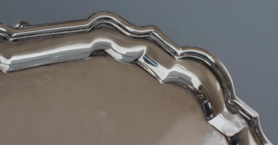 A SILVER SALVER, by Hamilton & Co., London 1927, of shaped circular form with piecrust rim, raised Image