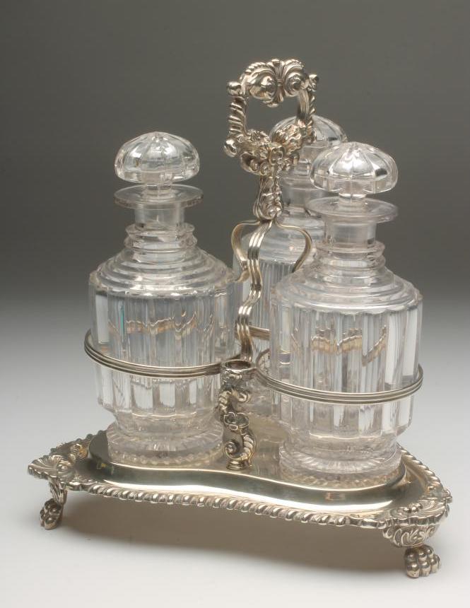 A LATE GEORGE III SILVER TRIPLE DECANTER STAND Image