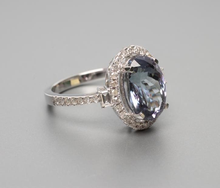 A TANZANITE AND DIAMOND CLUSTER RING Image