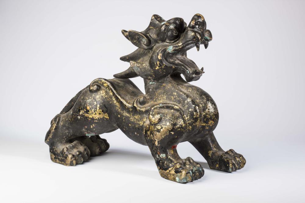 A CHINESE BRONZE TEMPLE DOG standing with open mouth and scroll moulded body Image