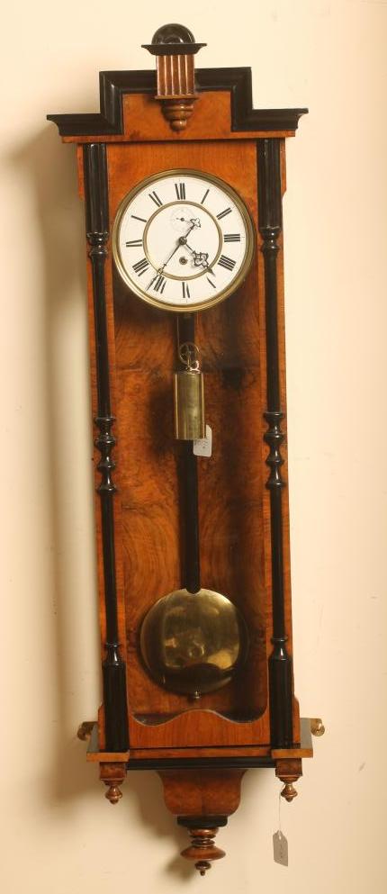 A WALNUT AND EBONISED VIENNA TYPE WALL TIMEPIECE Image