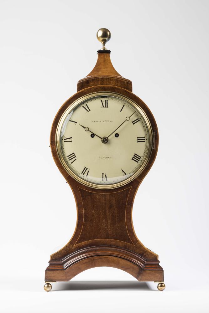 A GEORGE III STYLE MAHOGANY BALLOON CASED MANTEL CLOCK by Mappin & Webb Image