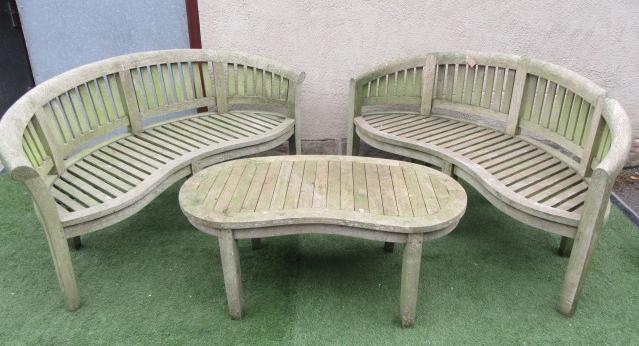 A PAIR OF SLATTED TEAK GARDEN BENCHES Image
