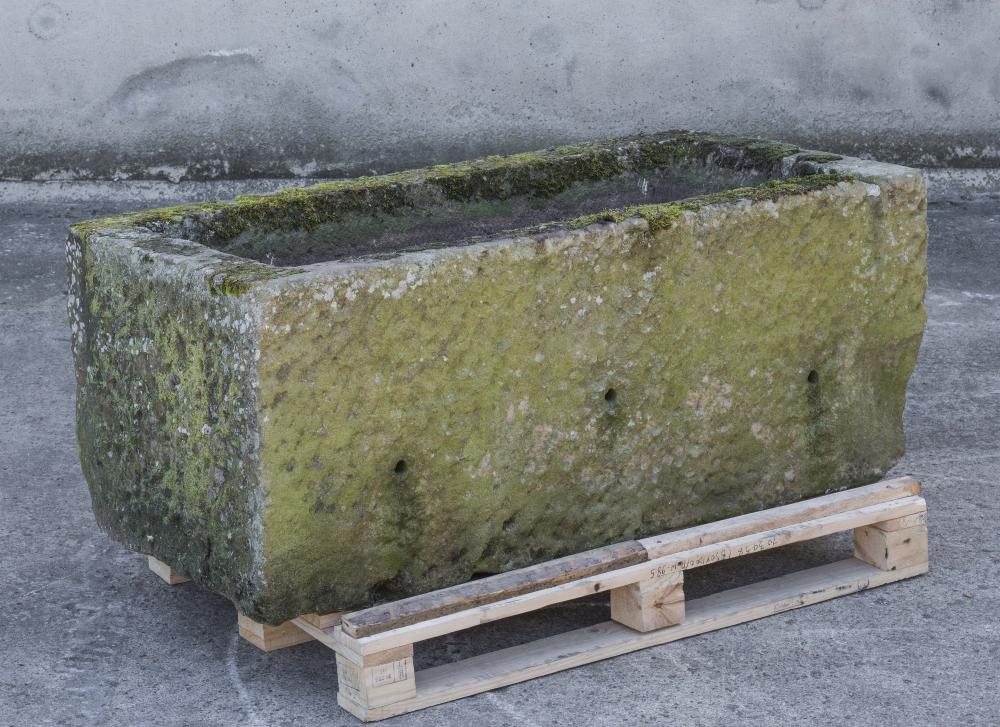 A LARGE SANDSTONE WATER TROUGH of textured oblong form Image