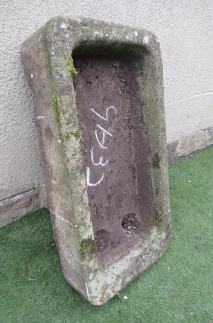A SANDSTONE TROUGH of rough hewn rounded oblong form Image