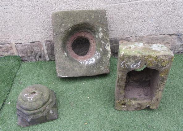 A SANDSTONE DRAIN SURROUND of rough hewn square form with central opening Image