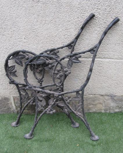 A PAIR OF VICTORIAN CAST IRON BENCH ENDS pierced and moulded with a fruiting bramble Image