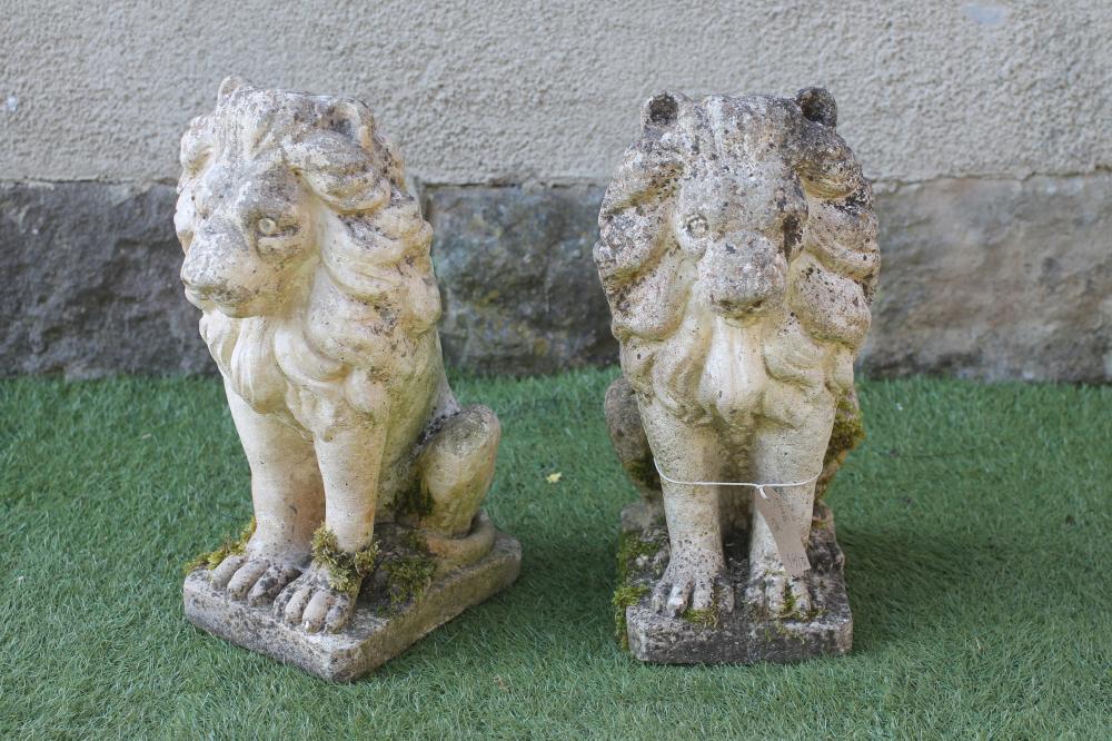 A PAIR OF COMPOSITION STONE RECUMBANT LIONS Image