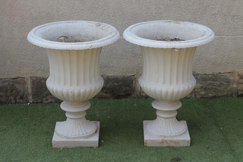 A PAIR OF VICTORIAN CAST IRON GARDEN URNS of half fluted campana form with ovolu moulded rim Image