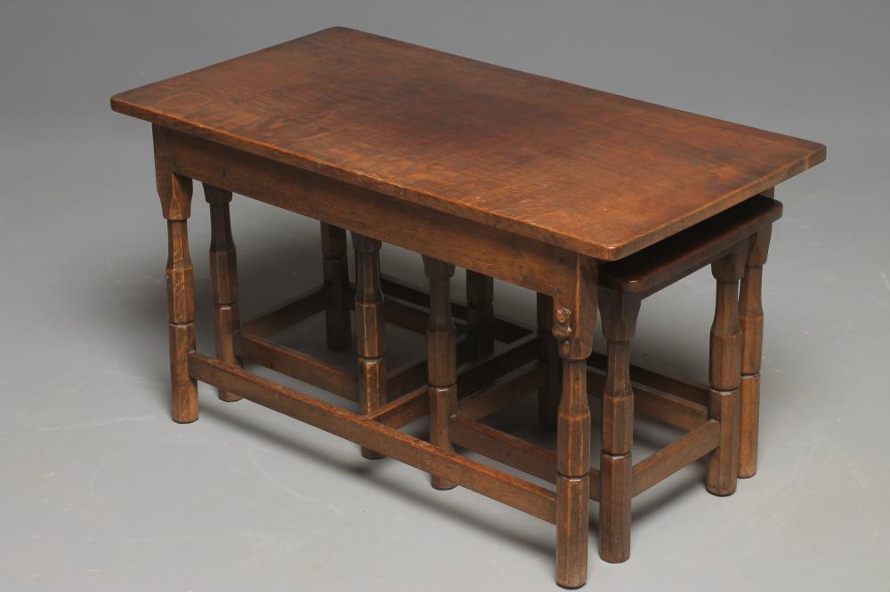 A NEST OF ADZED OAK COFFEE TABLES by Colin Almanac comprising a large table of rounded oblong form Image