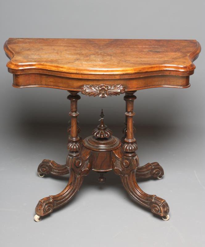 A VICTORIAN WALNUT FOLDING CARD TABLE of oblong serpentine form Image