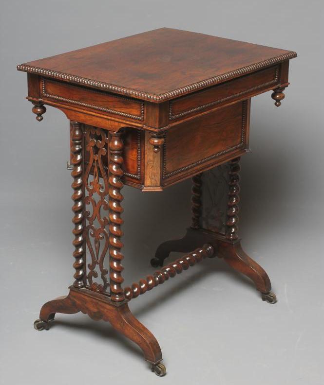 AN EARLY VICTORIAN ROSEWOOD TEAPOY of oblong form with bead and reel edging Image