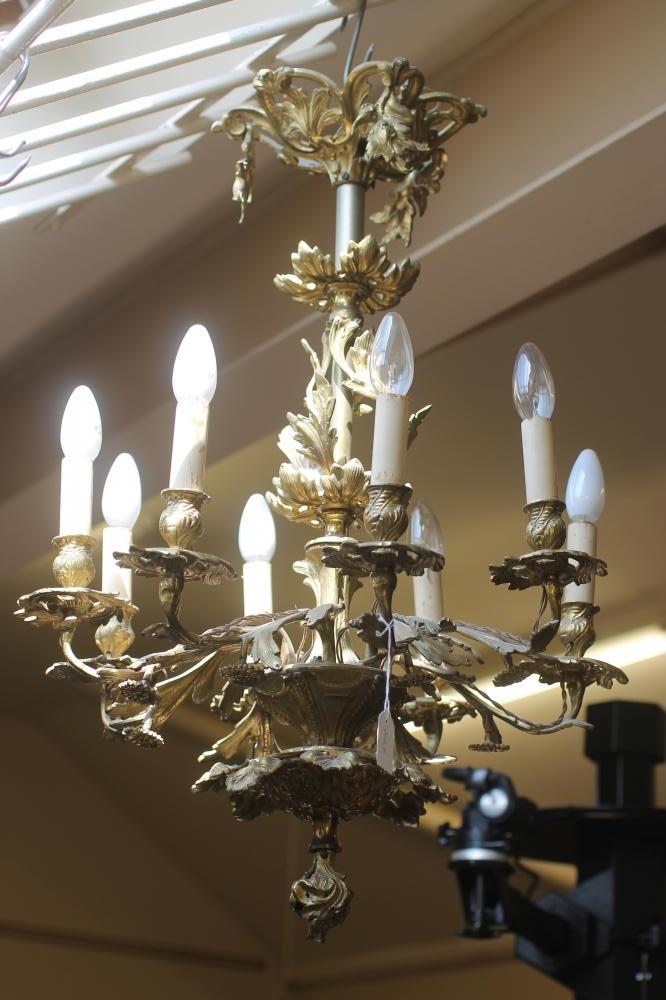A ROCOCO STYLE BRASS EIGHT LIGHT CHANDELIER Image