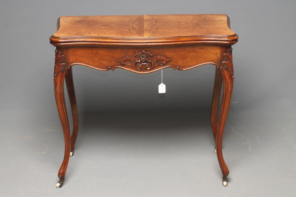 A LATE VICTORIAN WALNUT FOLDOVER CARD TABLE of serpentine oblong outline Image