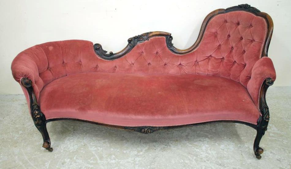A VICTORIAN WALNUT FRAMED SOFA of serpentine outline carved with flowers and foliate scrolls and Image