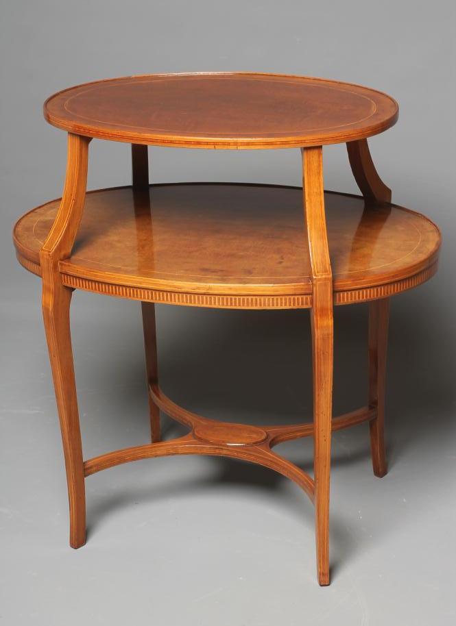 AN EDWARDIAN MAHOGANY ETAGERE of two tier oval form crossbanded with stringing Image
