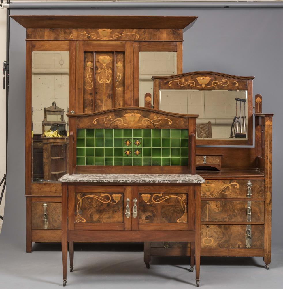 A VICTORIAN ART NOUVEAU WALNUT BEDROOM SUITE with marquetry flowers and white metal drop handles on Image