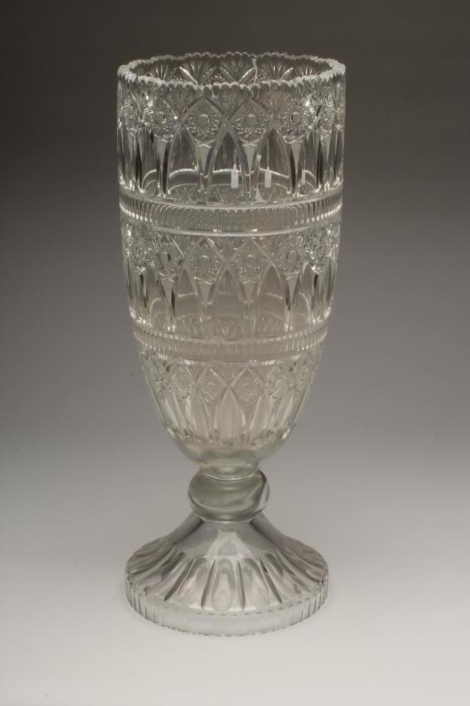A MASSIVE GLASS VASE of rounded cylindrical form on single knopped stem and swept foot Image