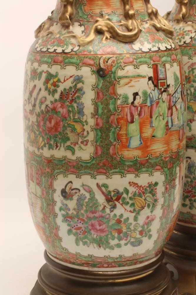 A PAIR OF CANTONESE PORCELAIN VASES of rounded cylindrical form with chi-long handles and Image