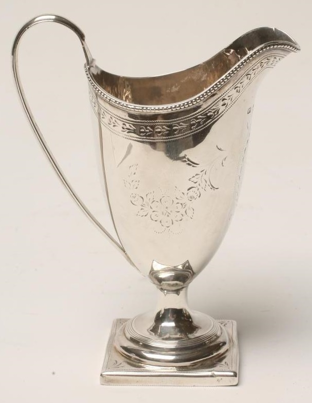 A GEORGE III SILVER PEDESTAL HELMET JUG Image