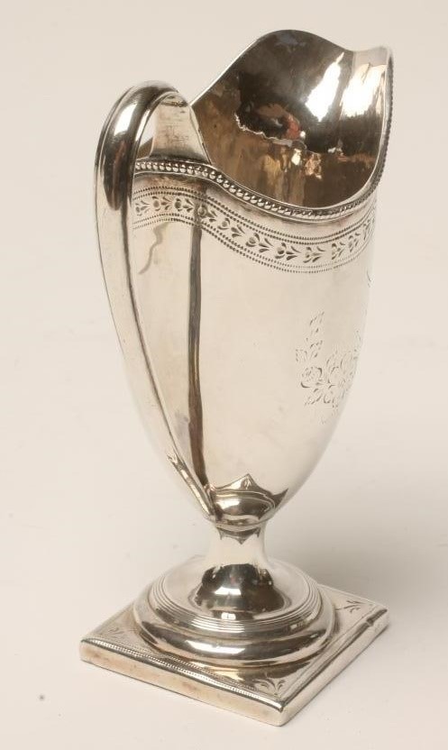 A GEORGE III SILVER PEDESTAL HELMET JUG Image