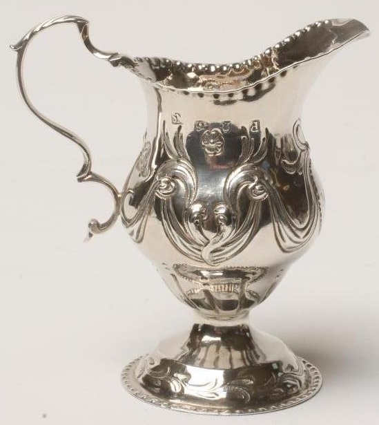 A GEORGE III SILVER CREAM JUG Image